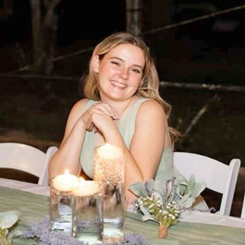 photo of aleisia at a table smiling